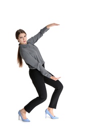 Young woman with magnet attracting people on white background