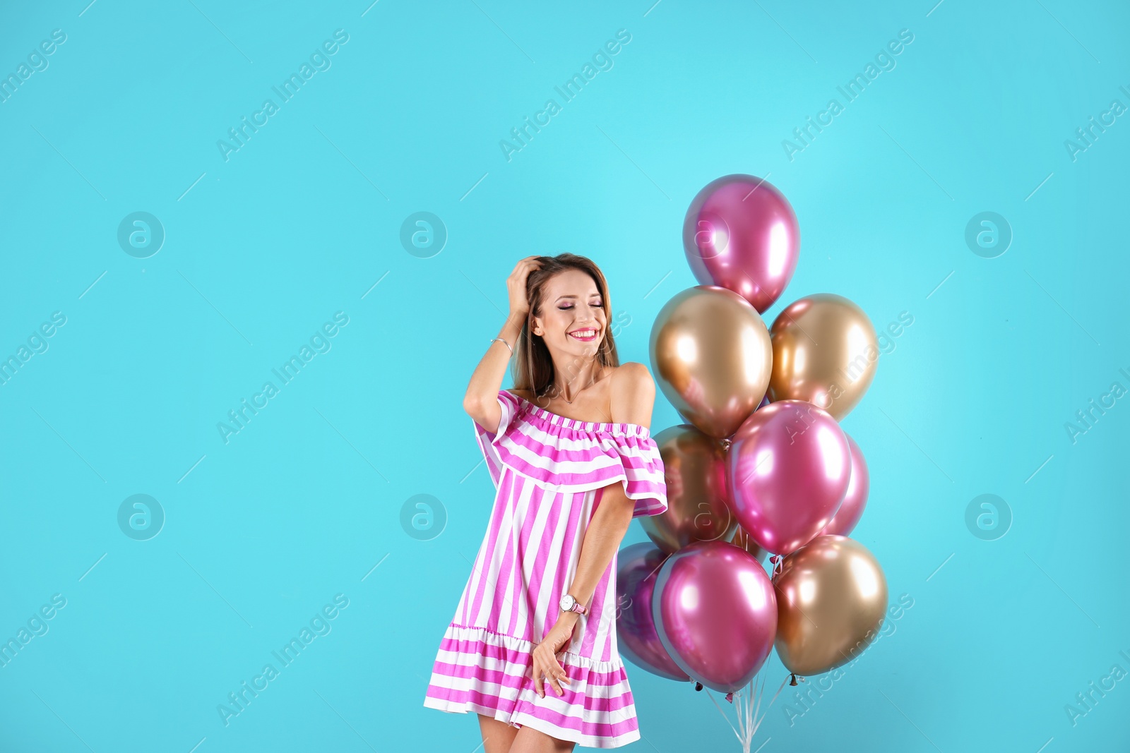 Photo of Young woman with air balloons and space for text on color background