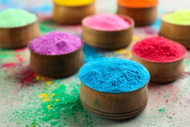 Colorful powder dyes on light background, closeup. Holi festival