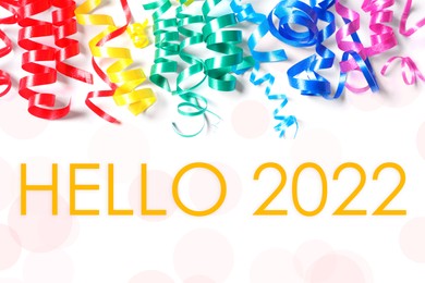 Text Hello 2022 and colorful serpentine streamers on white background, top view