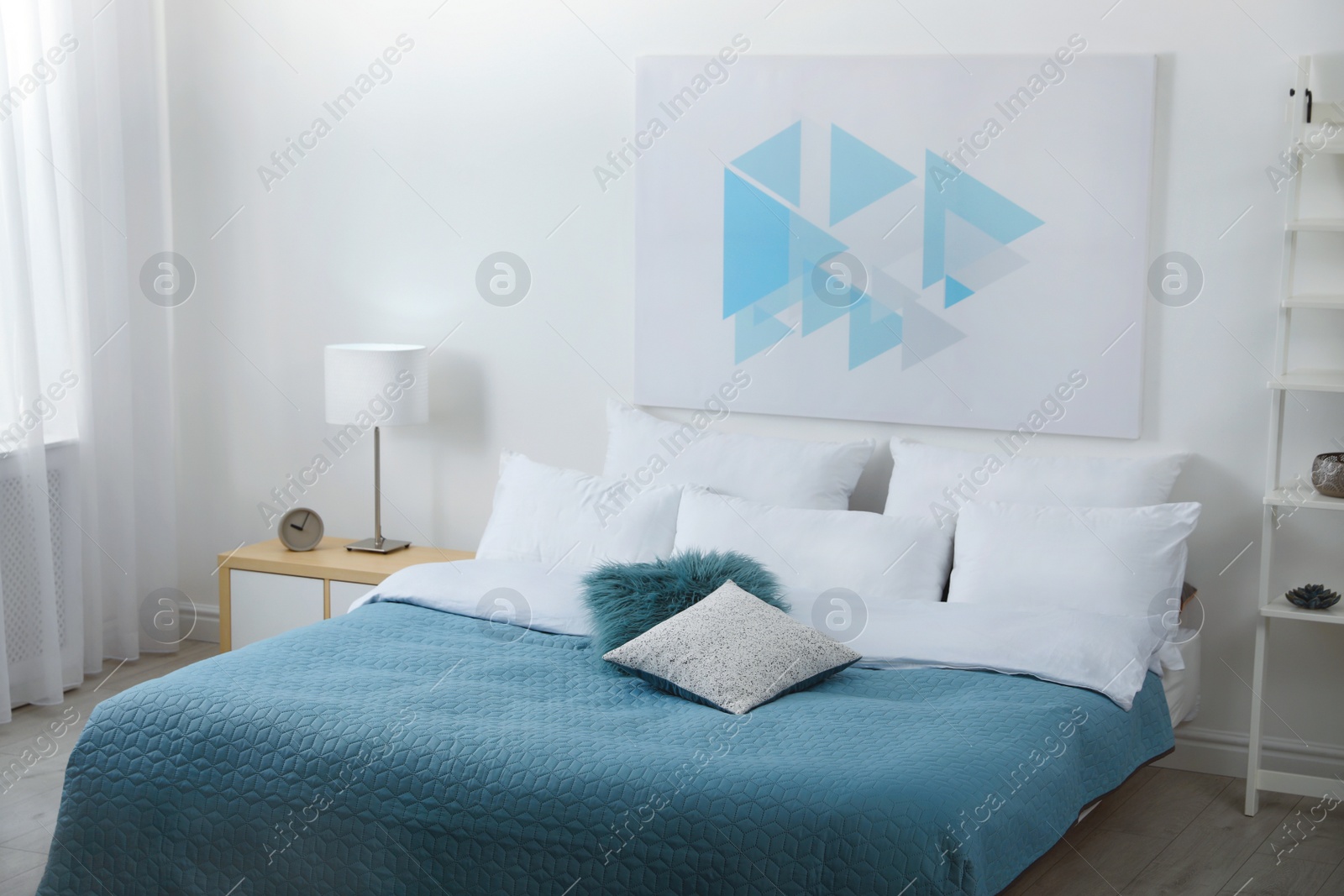 Photo of Light modern room interior with comfortable bed