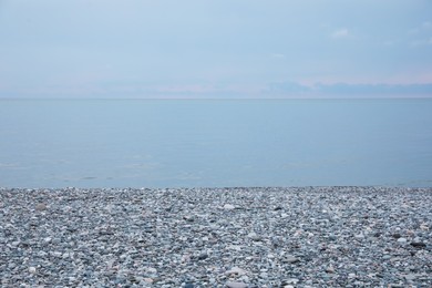 Picturesque view of beach with pebbles near sea