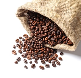 Photo of Overturned bag with roasted coffee beans on white background