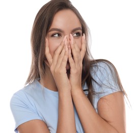 Embarrassed woman covering face with hands on white background