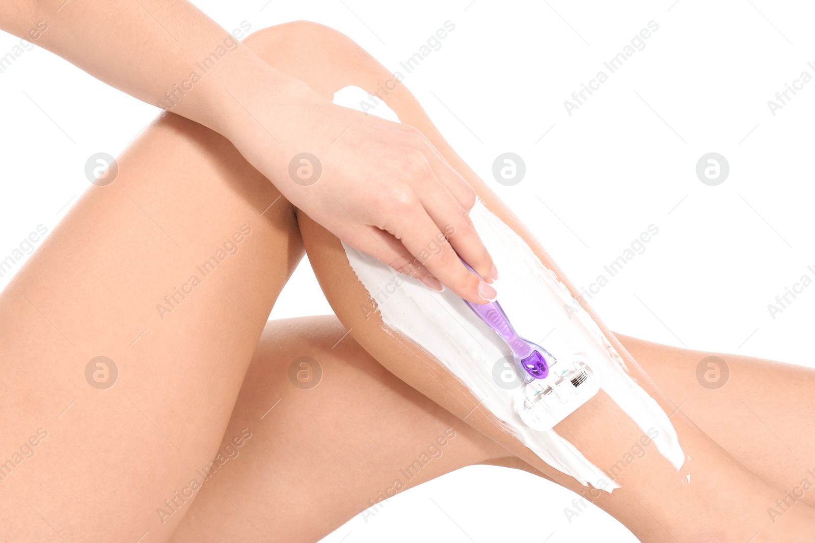 Photo of Beautiful young woman shaving leg on white background, closeup view