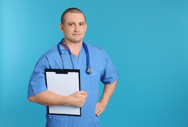 Portrait of medical assistant with stethoscope and clipboard on color background. Space for text