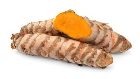 Photo of Fresh whole and cut turmeric roots isolated on white