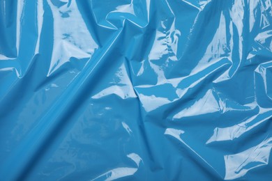 Photo of Light blue plastic stretch wrap film as background, top view