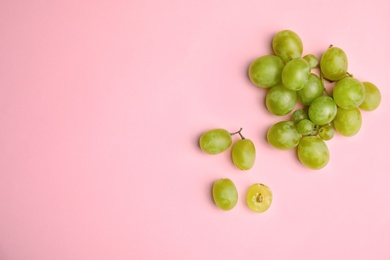 Fresh ripe juicy grapes and space for text on color background, top view