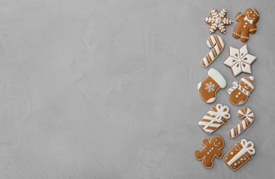Photo of Different Christmas gingerbread cookies on grey background, flat lay. Space for text