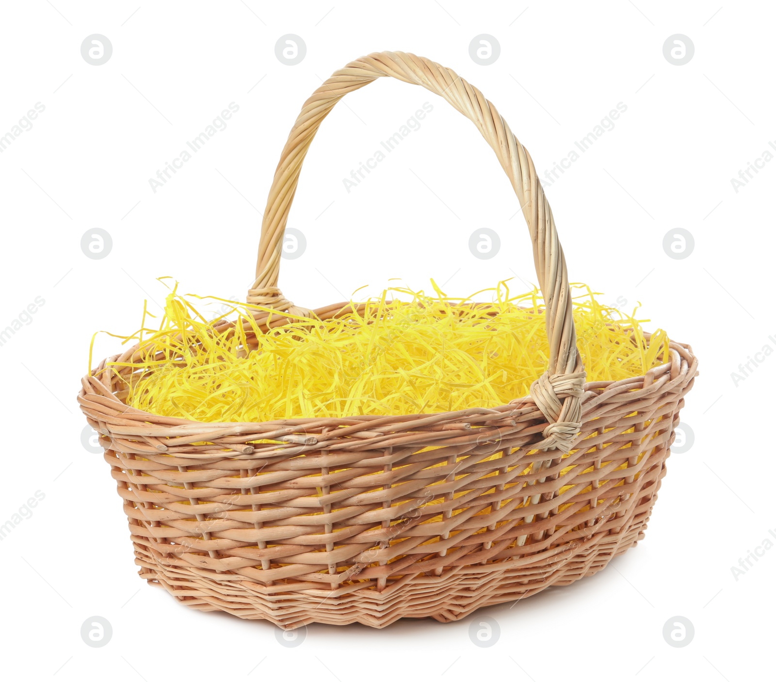 Photo of Wicker basket with yellow filler isolated on white. Easter item