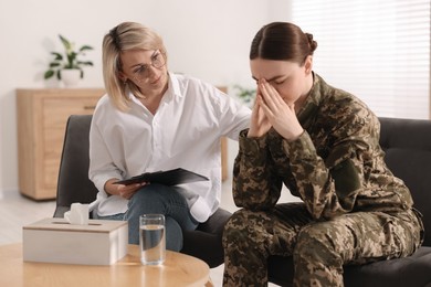 Psychotherapist working with military woman in office