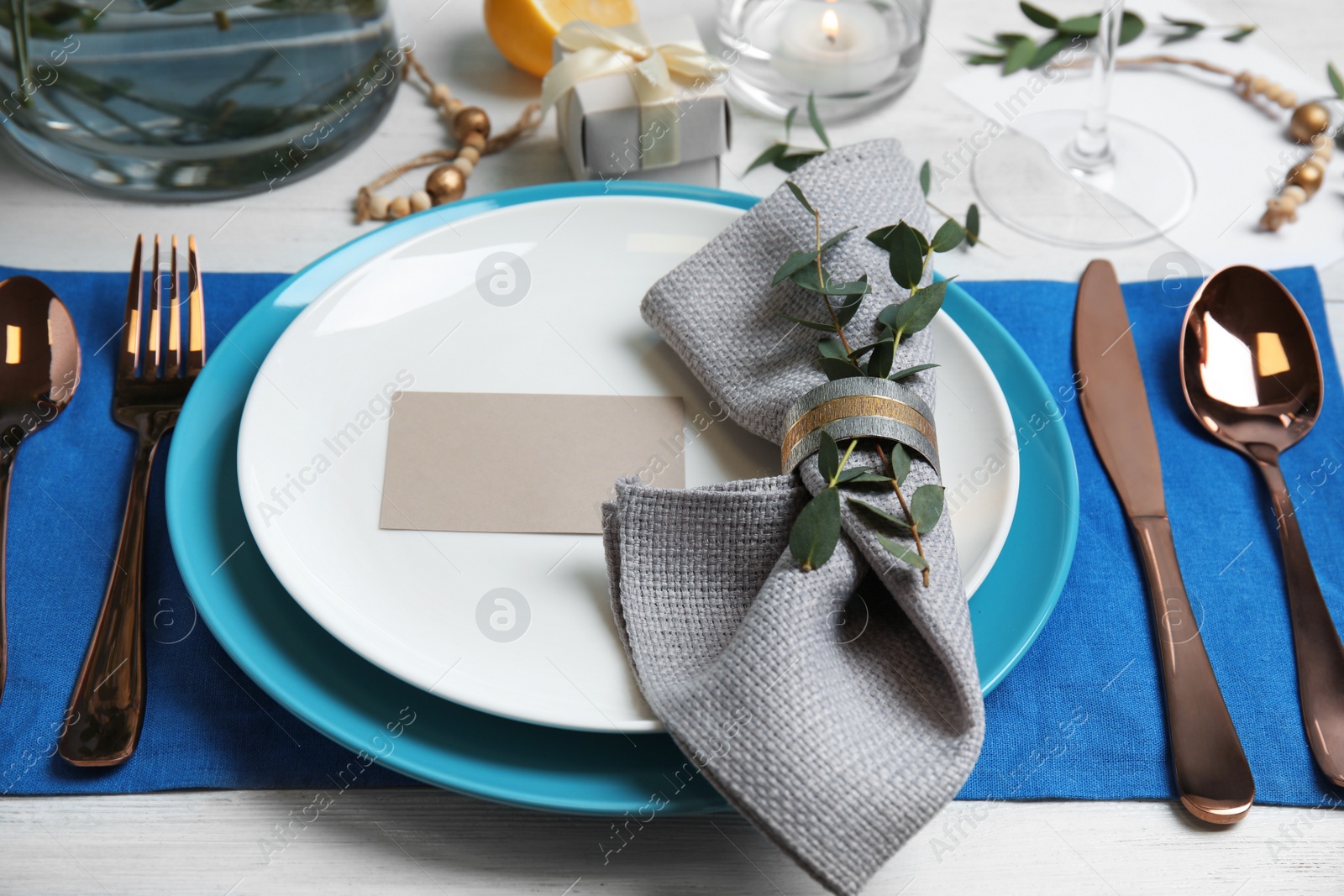 Photo of Elegant festive table setting with blank card on light background