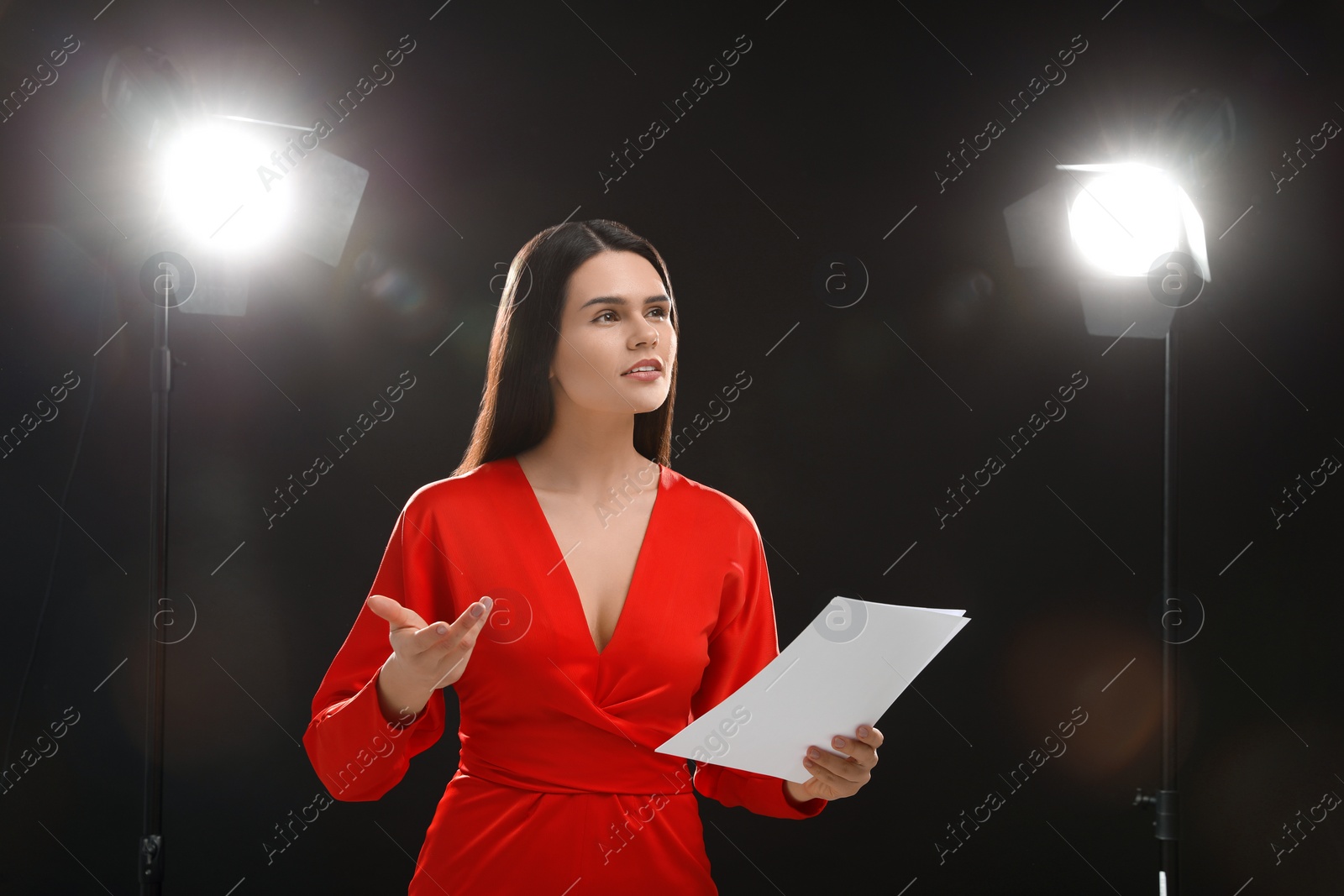 Photo of Actress with script performing on stage. Film industry