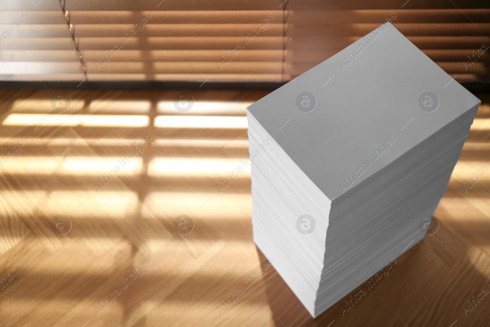 Photo of Stack of paper sheets on wooden table, above view