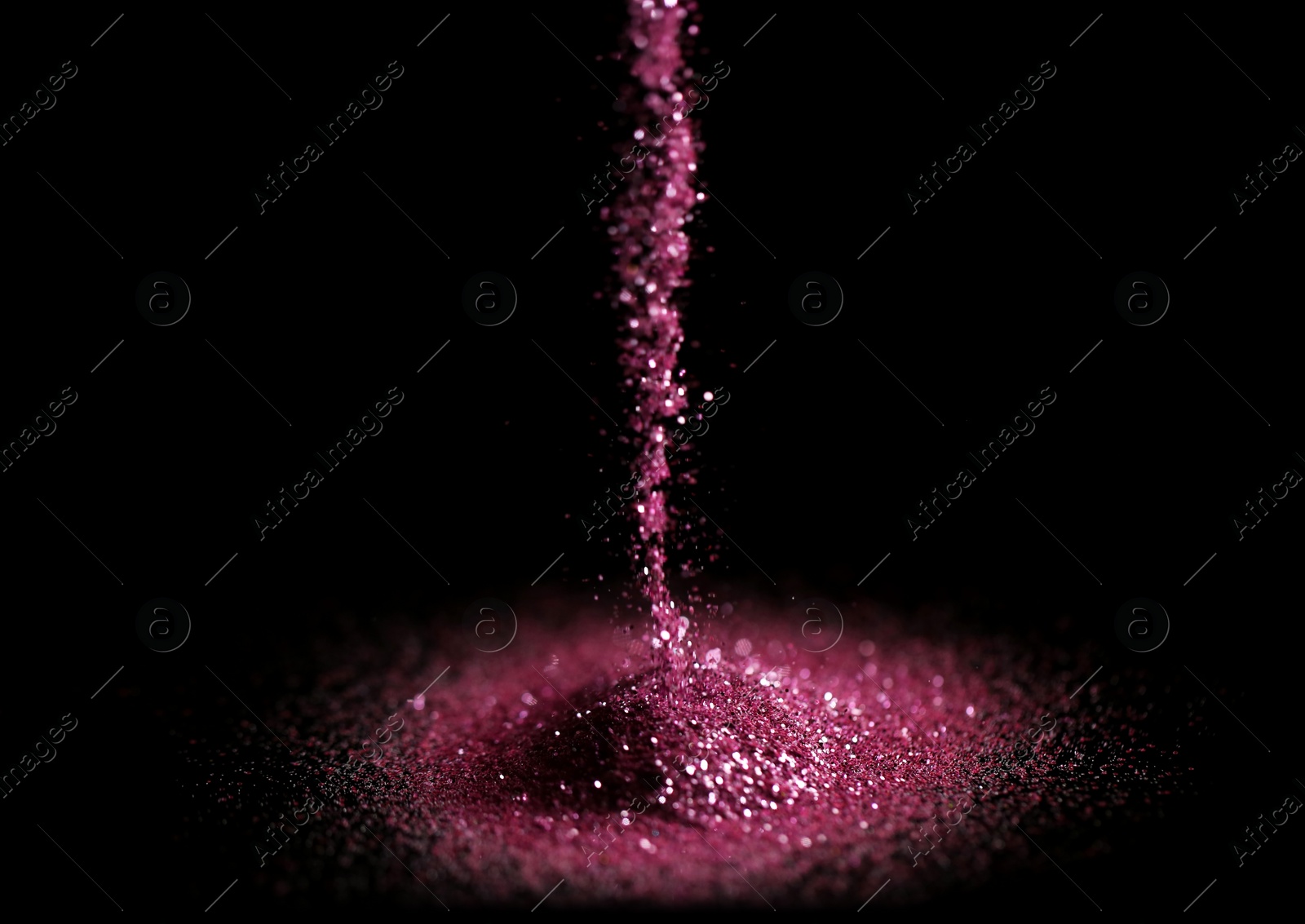 Photo of Sprinkling rose glitter on black background, bokeh effect