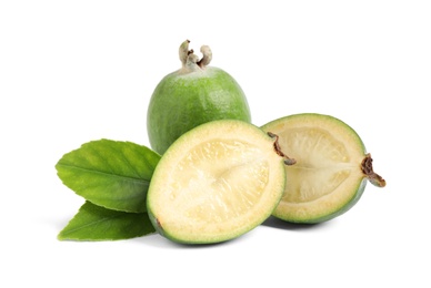 Cut and whole feijoas with leaves on white background