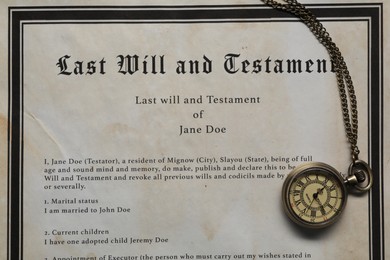 Photo of Last Will and Testament with pocket watch, top view