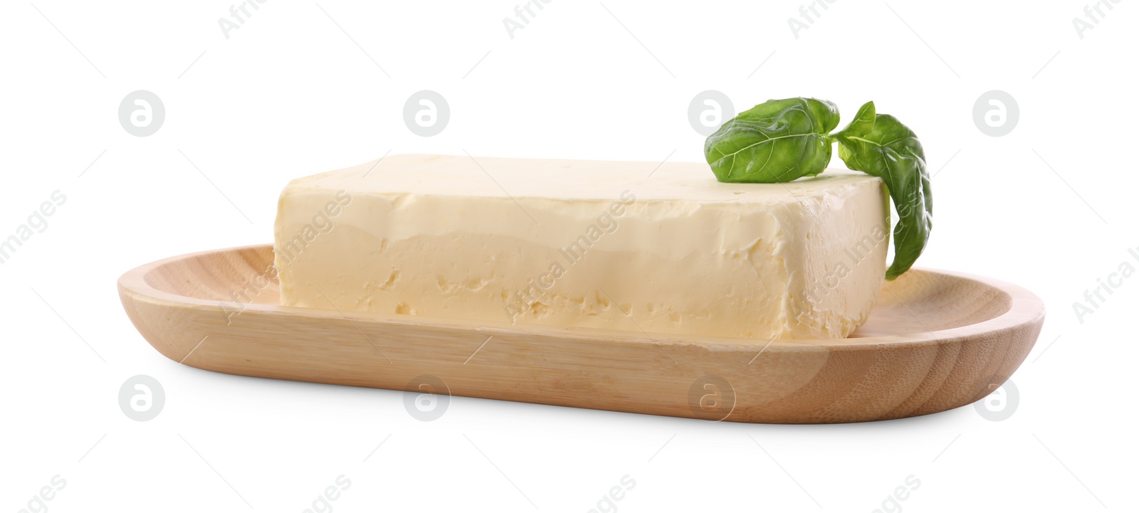 Photo of Block of tasty butter with basil isolated on white