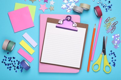Photo of Flat lay composition of clipboard with notes and other school stationery on light blue background, space for text. Back to school
