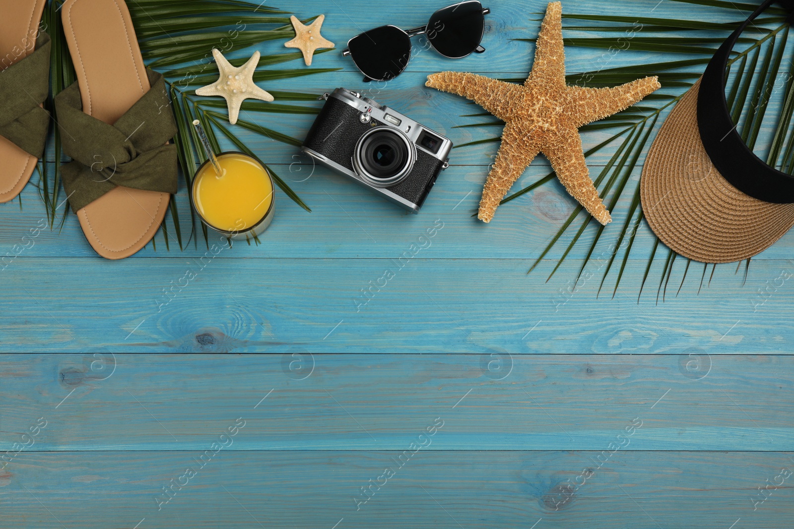 Photo of Flat lay composition with beach objects on turquoise wooden background, space for text