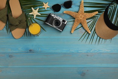 Flat lay composition with beach objects on turquoise wooden background, space for text