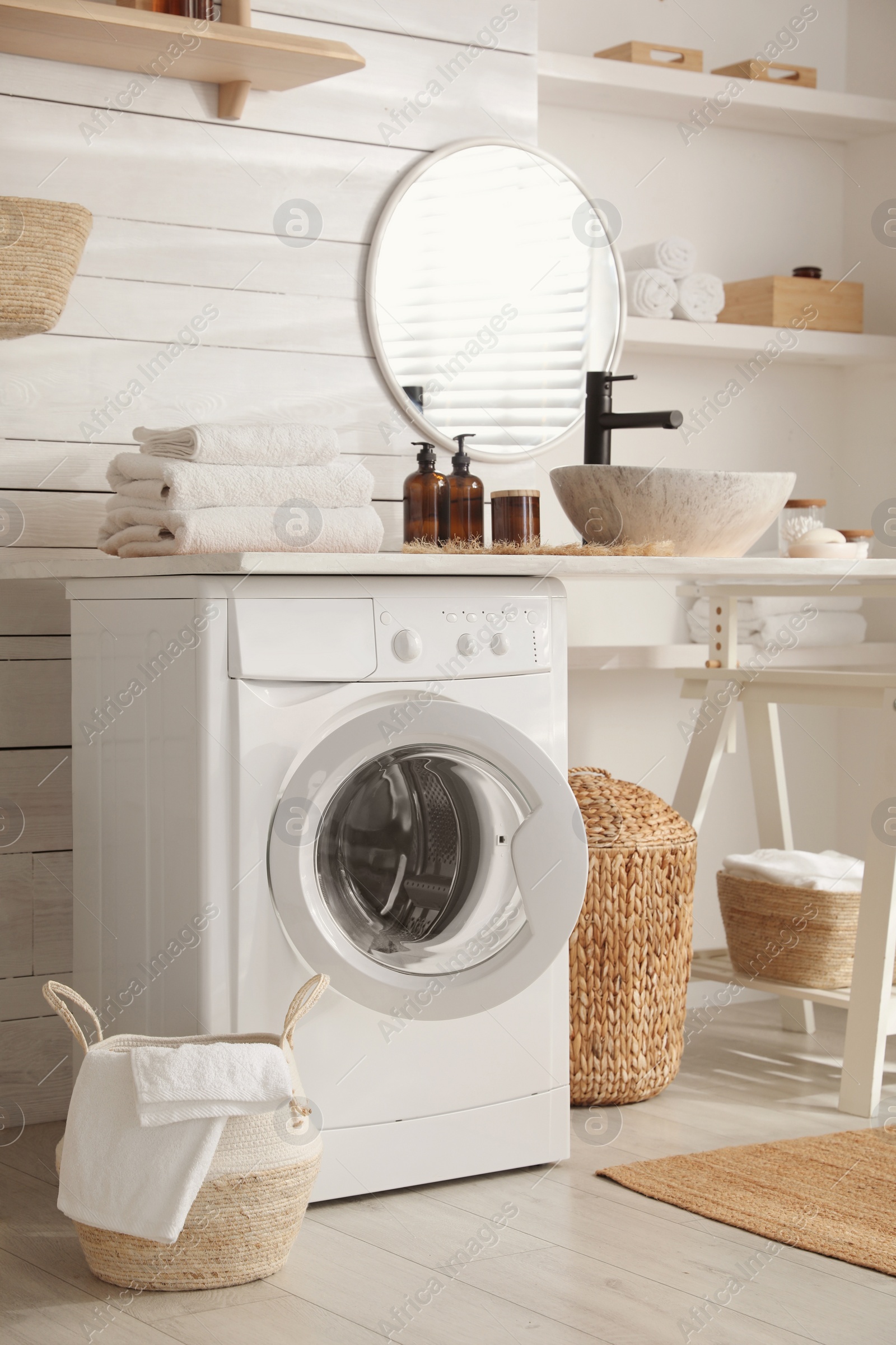 Photo of Stylish bathroom interior with modern washing machine