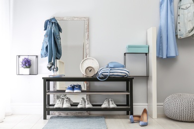 Photo of Cozy stylish hallway interior with shoe rack and mirror. Home design idea