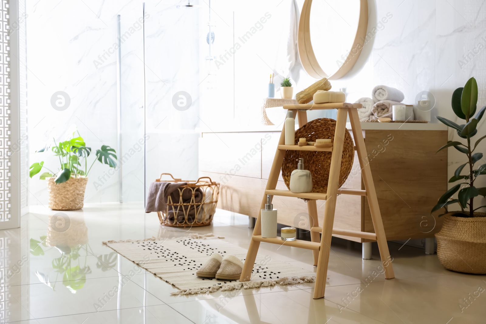 Photo of Dispensers and different toiletries on decorative ladder in bathroom. Idea for interior design