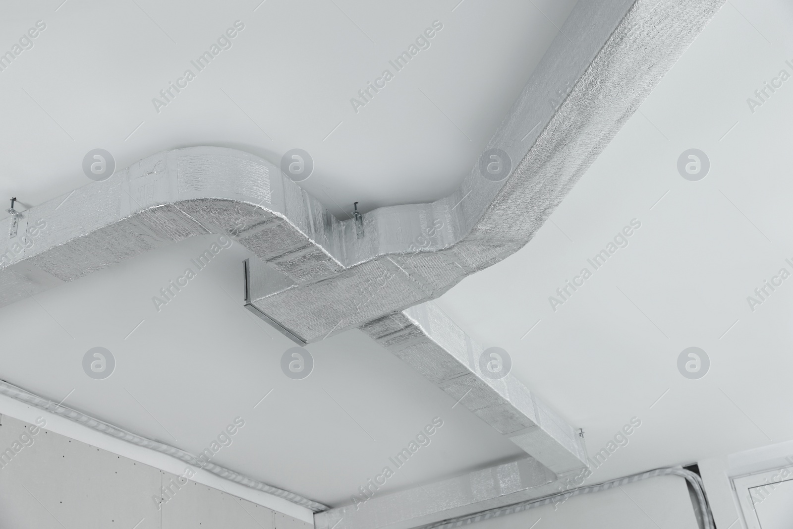 Photo of Ceiling with ventilation system indoors, low angle view