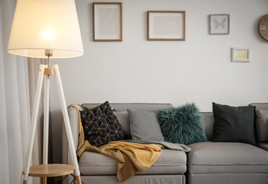 Modern living room interior with comfortable sofa and lamp