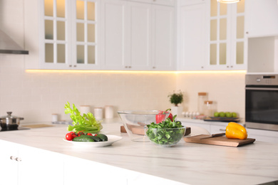 Fresh vegetables for salad on modern kitchen island