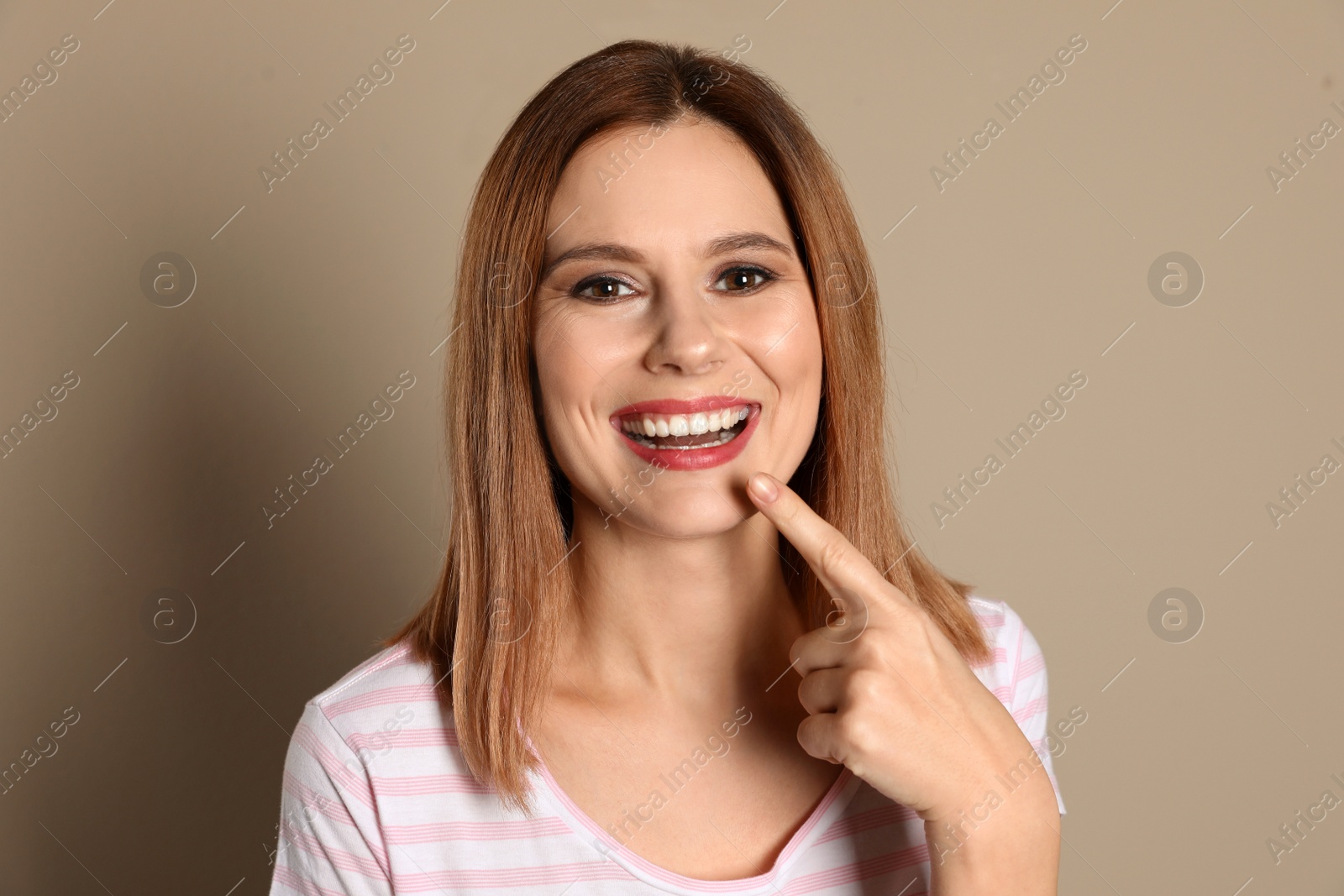 Photo of Smiling woman with perfect teeth on color background