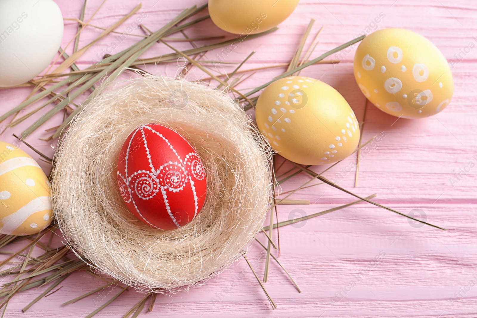 Photo of Flat lay composition with painted Easter eggs on table