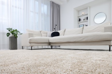 Photo of Fluffy carpet and stylish furniture on floor indoors, low angle view