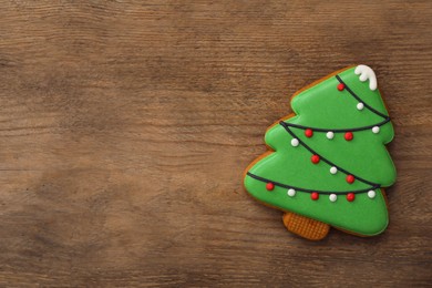 Christmas tree shaped cookie on wooden table, top view. Space for text