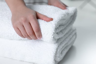 Photo of Woman touching soft white towel, closeup view