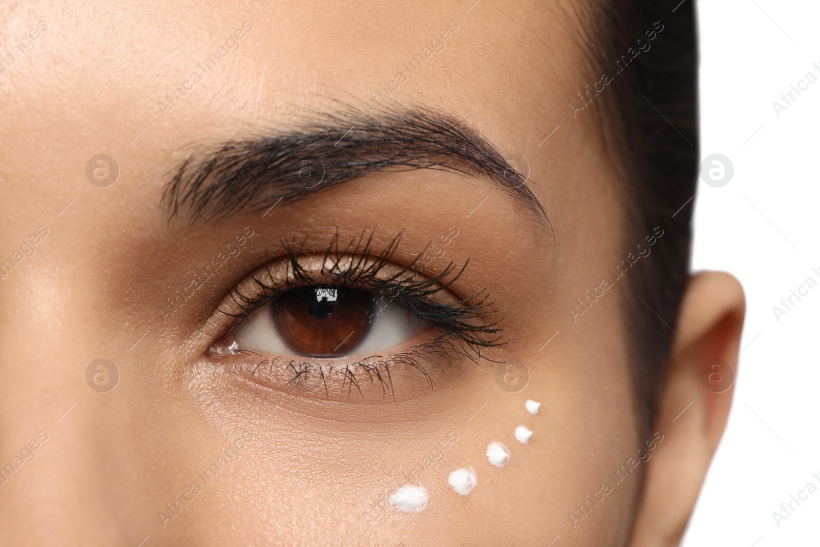 Photo of Woman with eye cream on white background, closeup. Skin care