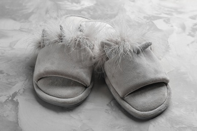 Photo of Pair of stylish soft slippers on grey background