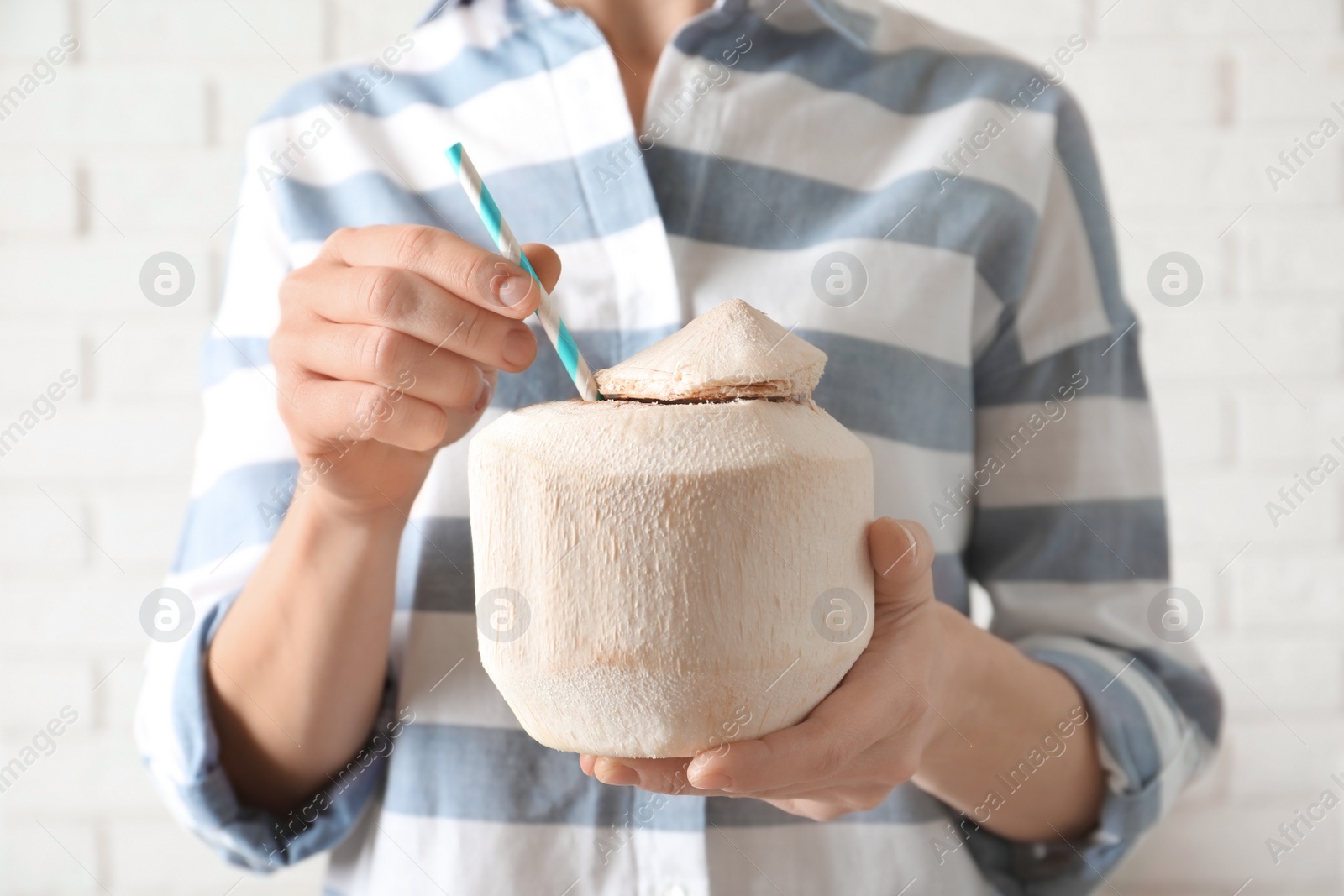 Photo of Woman with fresh coconut drink in nut, closeup