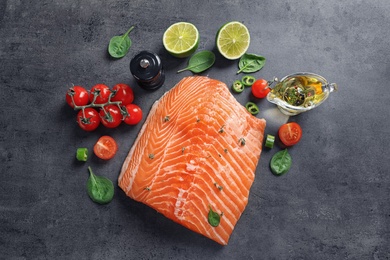Photo of Flat lay composition with raw salmon and ingredients for marinade on table
