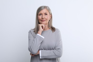 Portrait of beautiful senior woman on white background