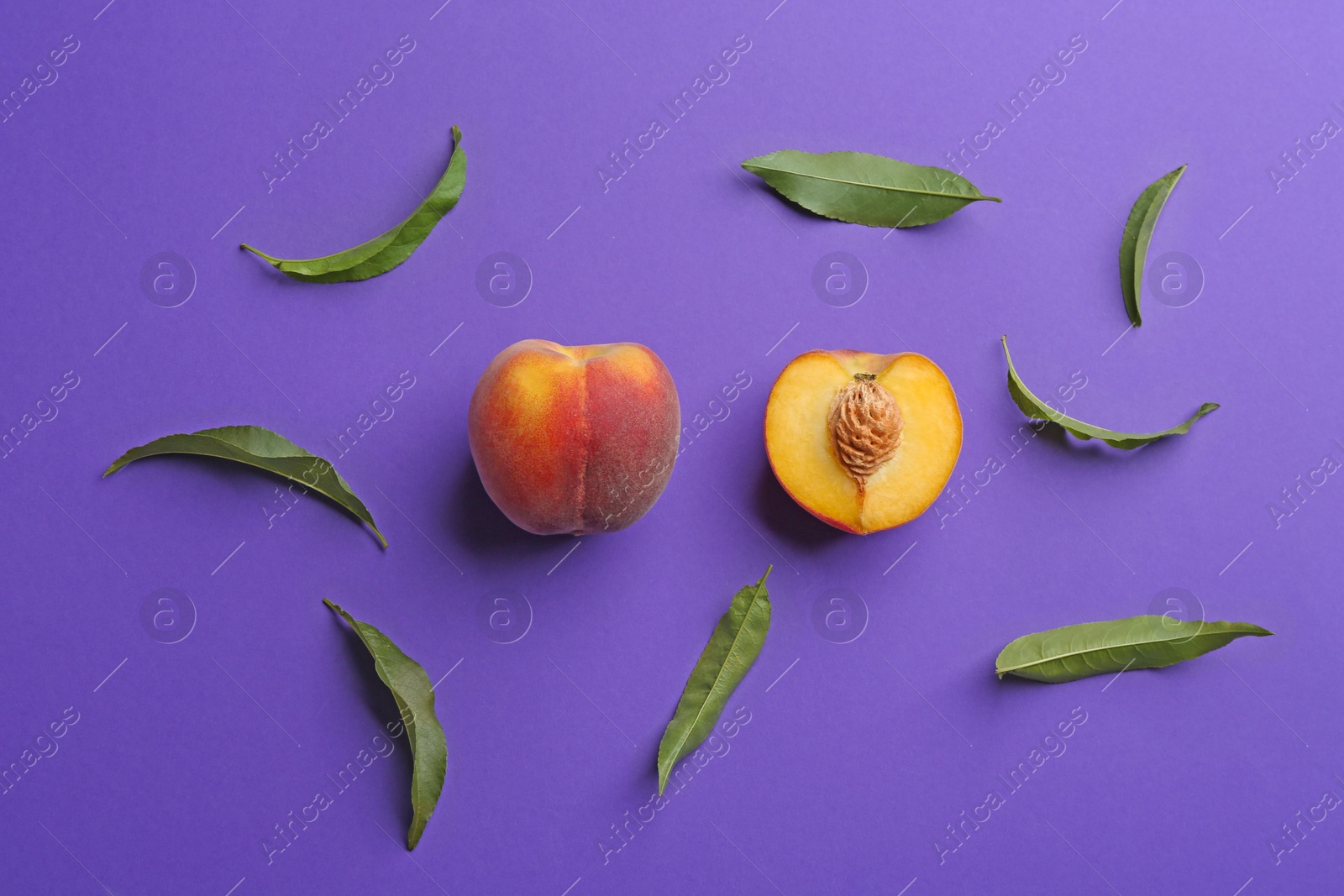 Photo of Flat lay composition with fresh peaches on purple background