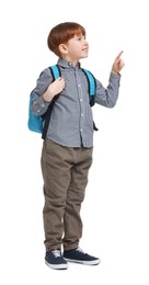 Photo of Little boy with backpack pointing at something on white background
