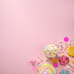 Flat lay composition with cupcake on pink background, space for text. Birthday party