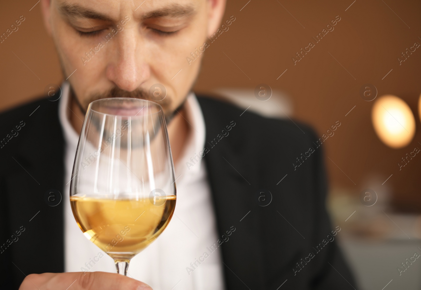 Photo of Young man with glass of wine indoors