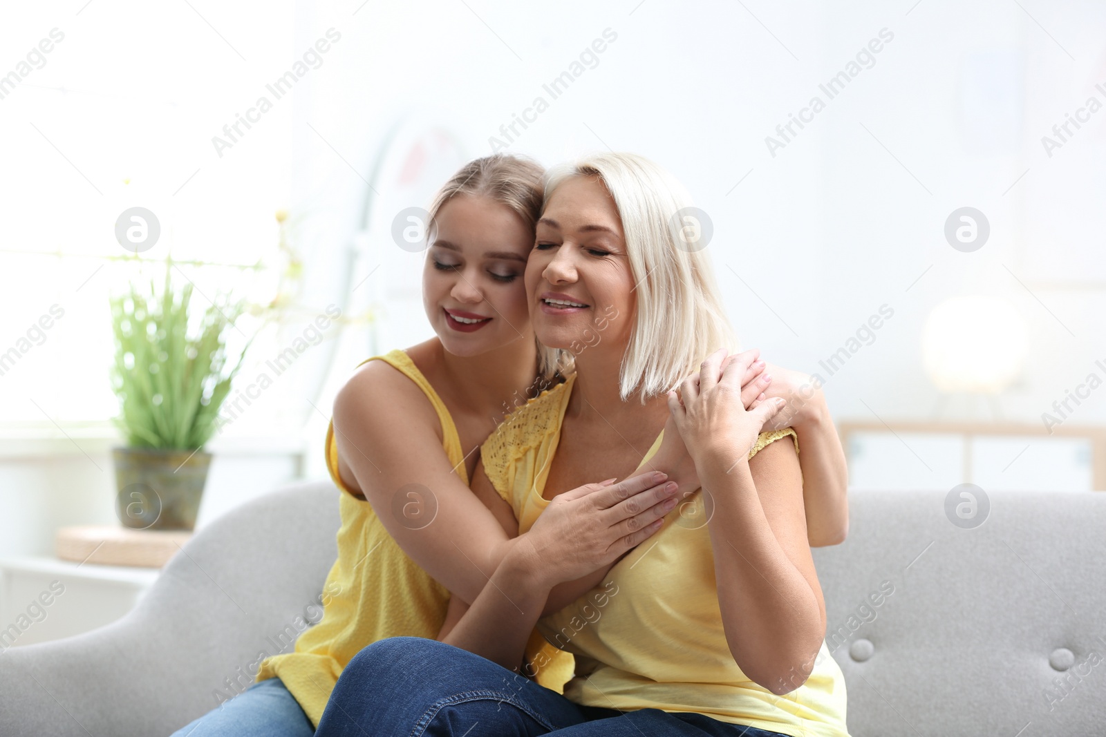 Photo of Mother and her adult daughter spending time together at home