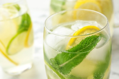 Glass of refreshing lemonade on table, closeup with space for text. Summer drink