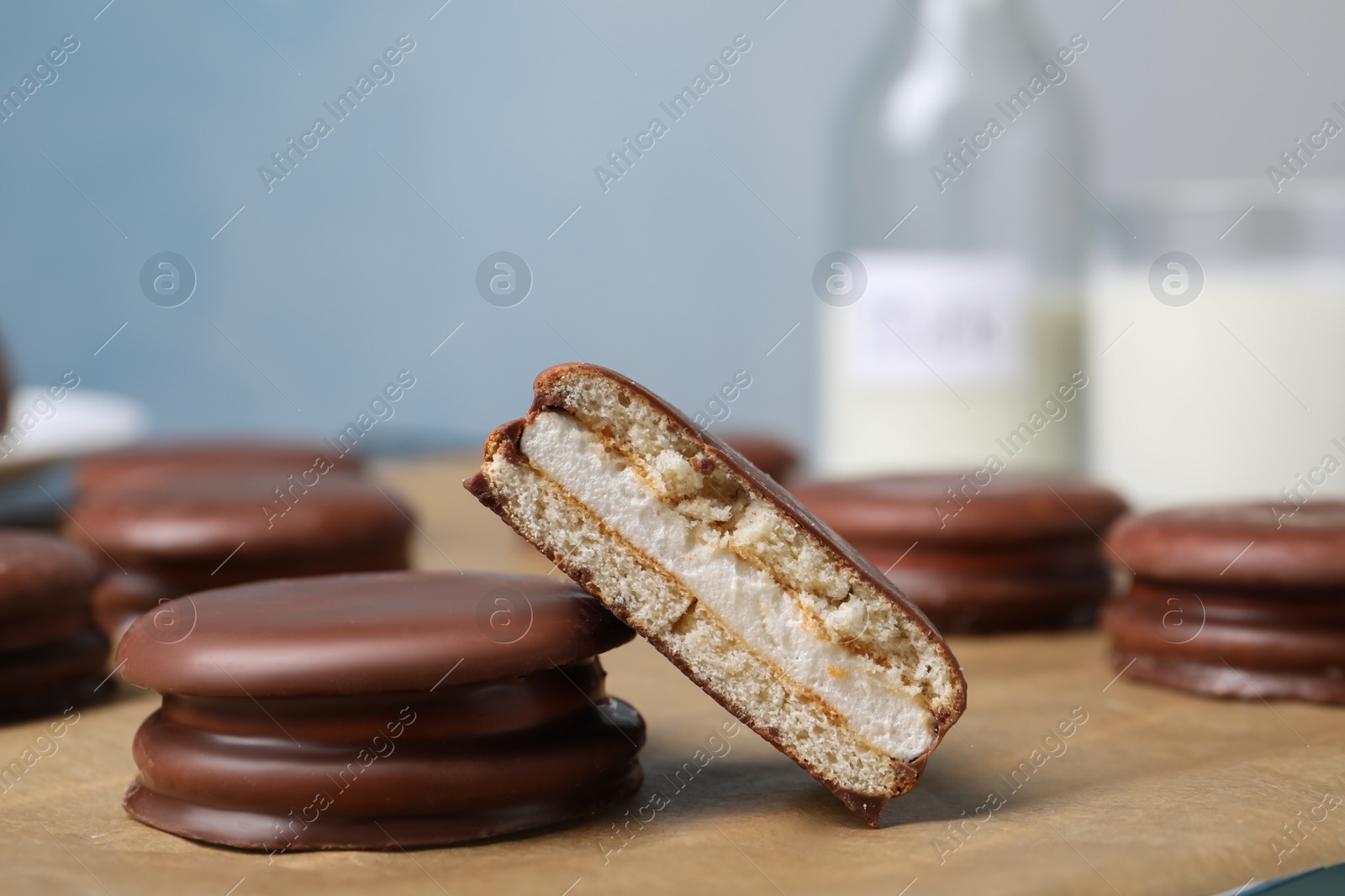 Photo of Tasty choco pies on parchment paper, closeup view