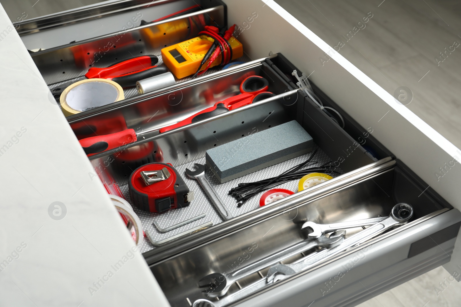 Photo of Set of instruments in open desk drawer indoors